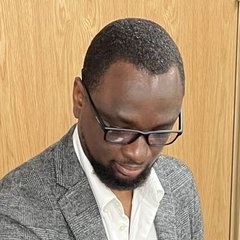 DJ Sticky at the decks during an event, wearing a grey blazer